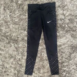 Nike Dri fit women black with dots Swoosh logo, side pocket leggings. Size S.
